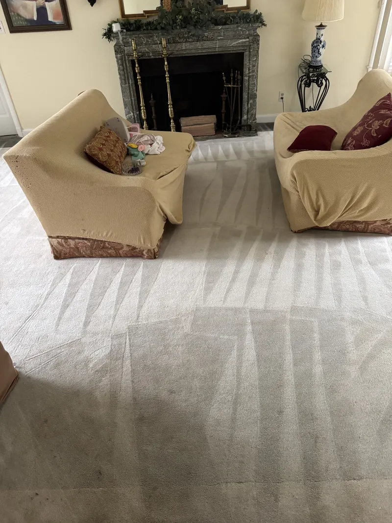 Cream wall to wall carpet with fresh cleaning wand lines in a living room with a fireplace