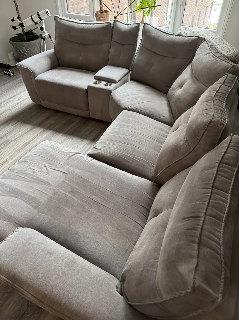 A large gray fabric sectional sofa in a living room